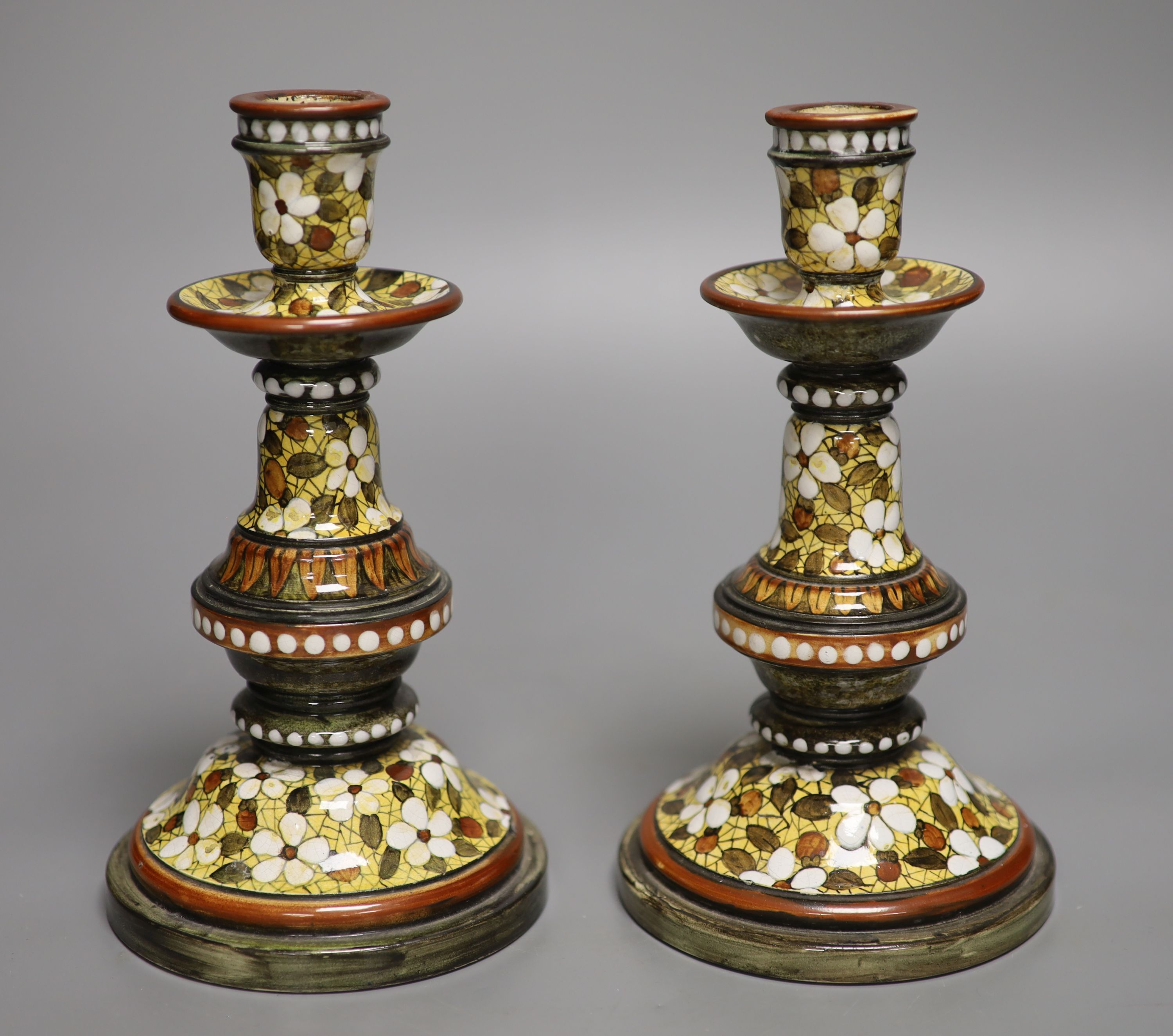 A pair of Doulton Lambeth candlesticks, decorated by Mary Butterton, height 20cm